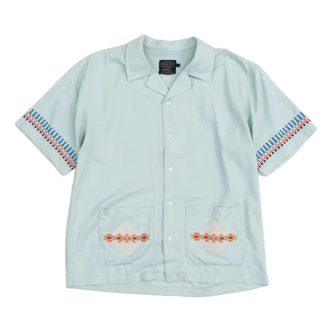 A green camp collar shirt with Pendleton needlework detail on the pockets and sleeves, displayed on a white background.